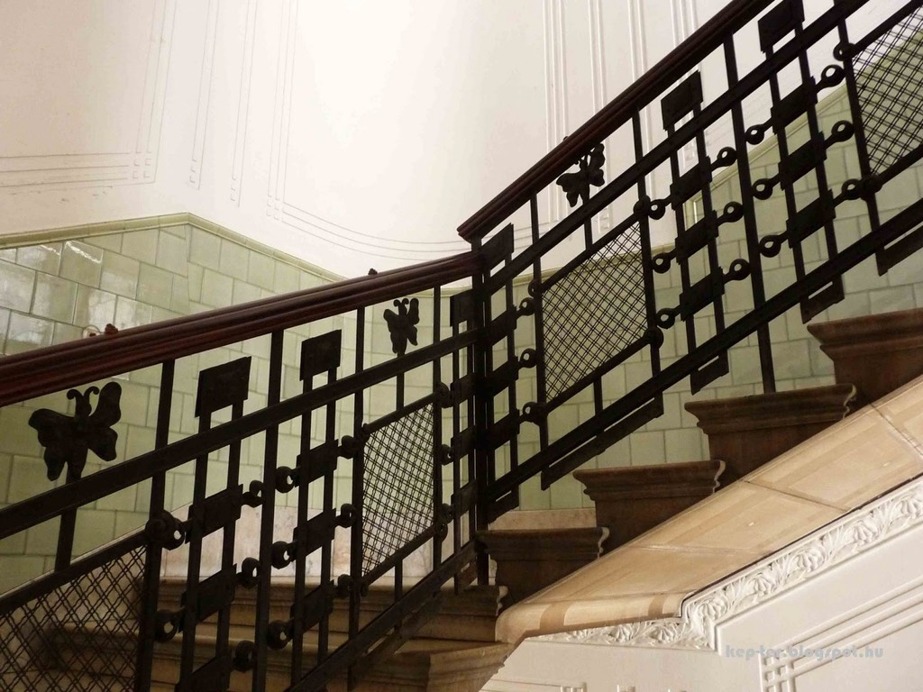 The wrought-iron railing of the staircase