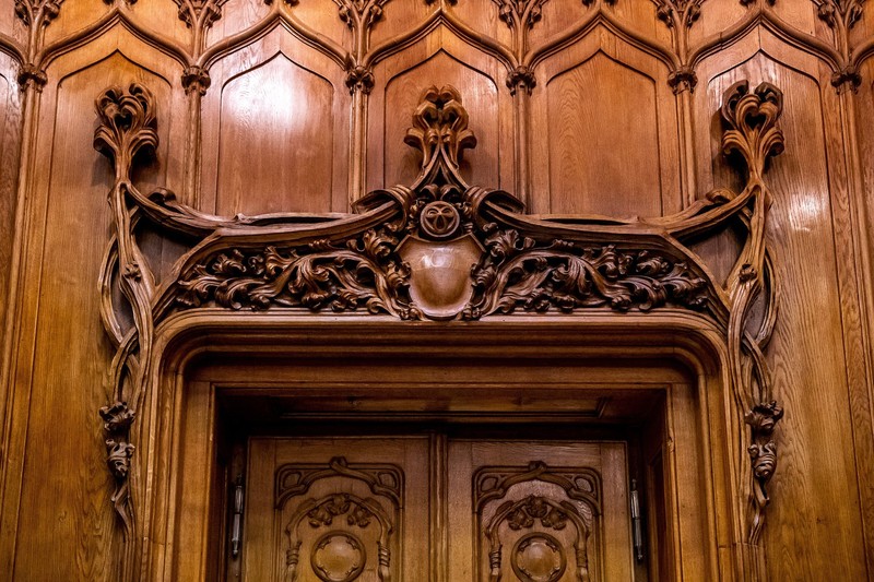 The wood carvings above a door in the hall