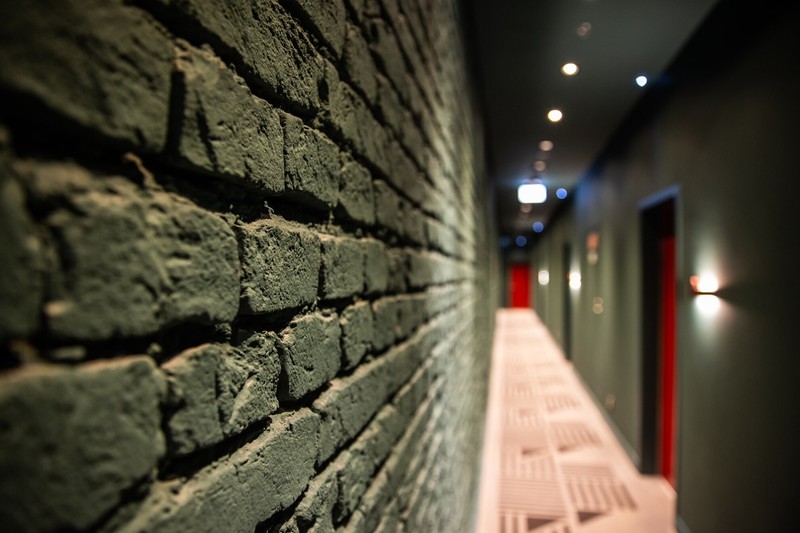 The original brick wall of a hallway