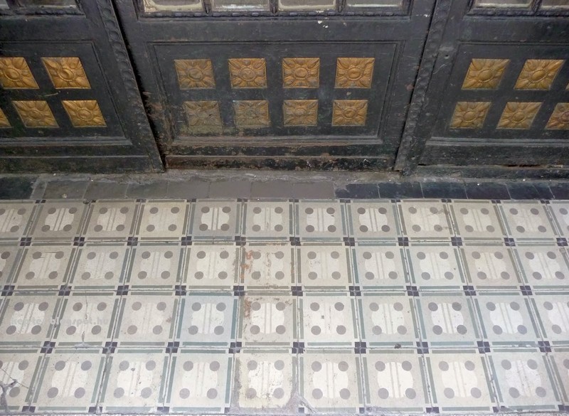 The tile flooring on the street by the gate